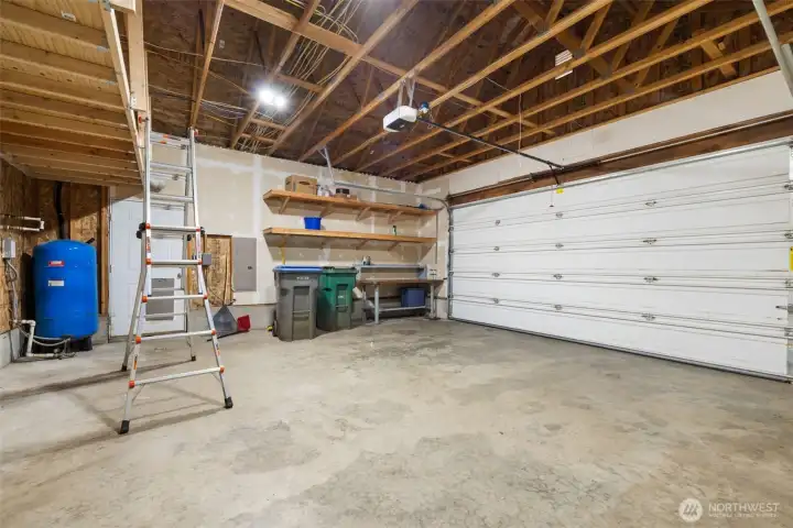 Tall garage w/built in shelving and auto door