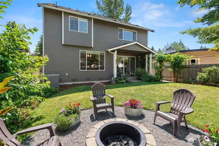 Enjoy the custom fire pit in the backyard. A great opportunity to unwind in a serene backyard with lush vegetation.