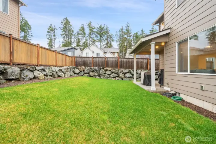 Fully fenced backyard w/ covered patio Fully fenced backyard w/ covered patio