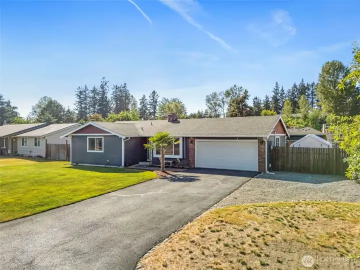 Large driveway with double gates/parking on the right side of home.