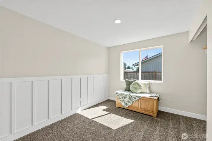 Second bedroom with decorative wall panel, new carpet