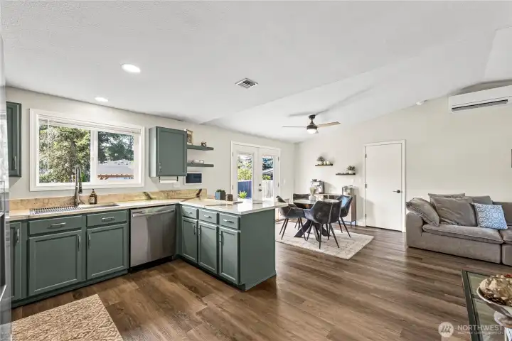 Open-concept kitchen flowing into the dining area with a breakfast bar, perfect for casual dining and entertaining
