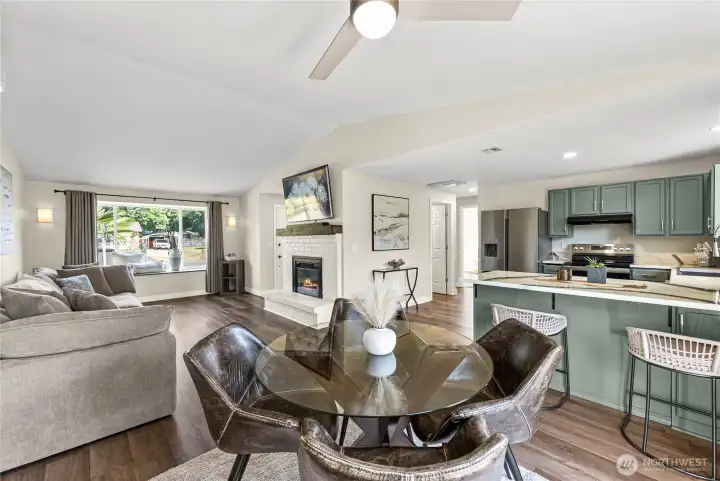 Vaulted ceiling in living room with LVP floor extending throughout home