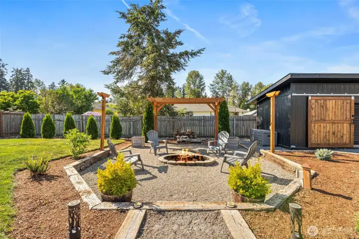 Walk out through french doors to a large backyard with fire pit for outdoor entertaining
