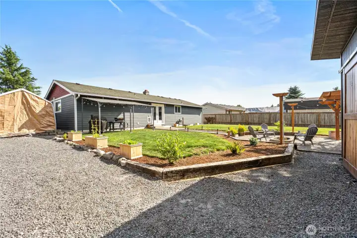 Flexible parking for RVs, boats, and cars with expansive garden area