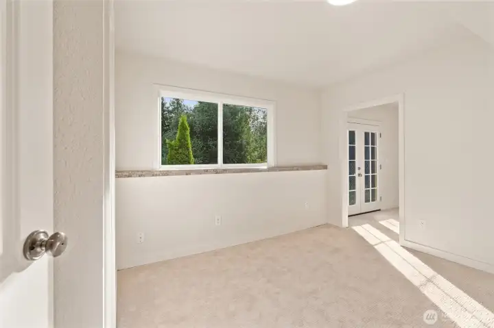 The lower-level suite includes an en suite bath, generous walk-in closet with sliding barn door, and private deck access through french doors. The lower-level suite includes an en suite bath, generous walk-in closet with sliding barn door, and private deck access through french doors.