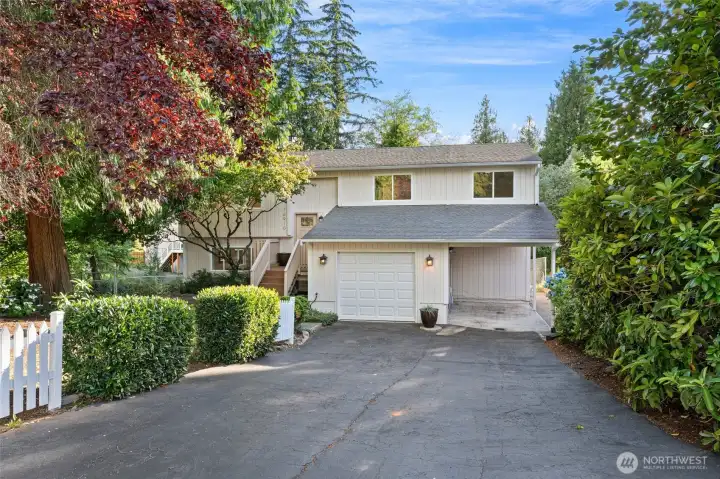 Garage, carport, and generous driveway space offer versatility for multiple vehicles, storage, and guests. Garage, carport, and generous driveway space offer versatility for multiple vehicles, storage, and guests.