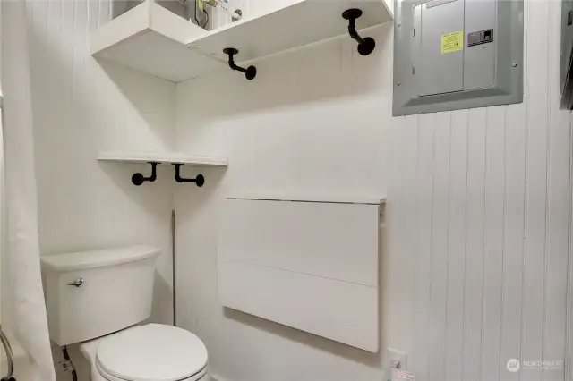 TOILET NEXT TO WASHER DRYER WITH DROP DOWN FOLDING TABLE FOR LAUNDRY