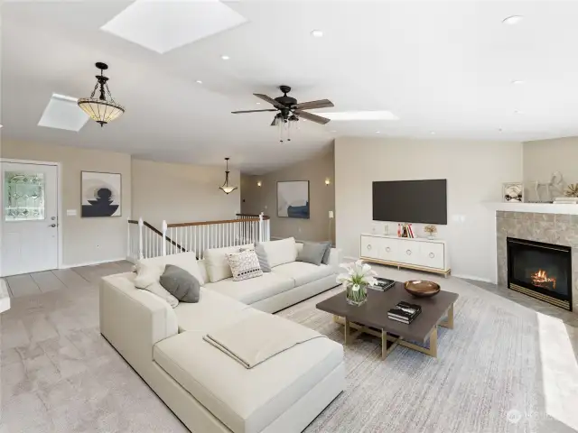 Main Level Living Area with Gas Fireplace, Vaulted Ceilings & Skylights (virtually staged)