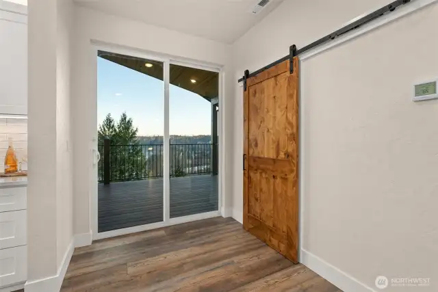 Sliding glass door out to covered deck & sliding door to butlers pantry.