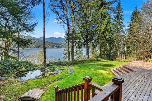 Enjoy the water views from the covered back deck with the sounds of the waterfall into the pond.