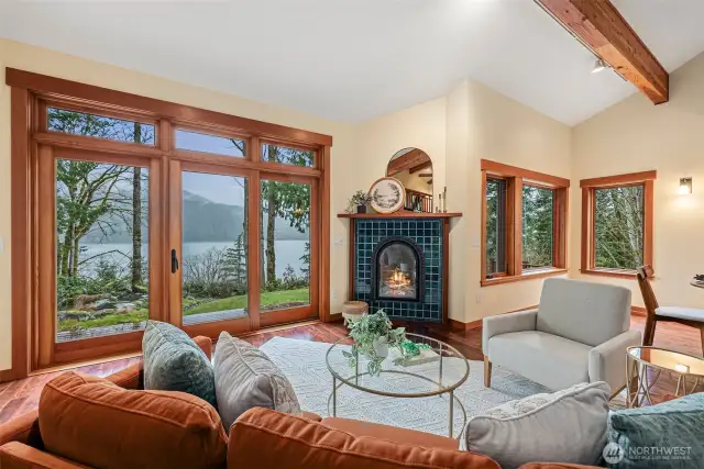 Cozy living room with water views & custom gas fireplace