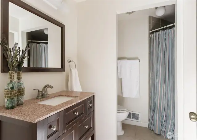 Downstairs bathroom, washer/dryer is to the right, opposite the sink in a cove