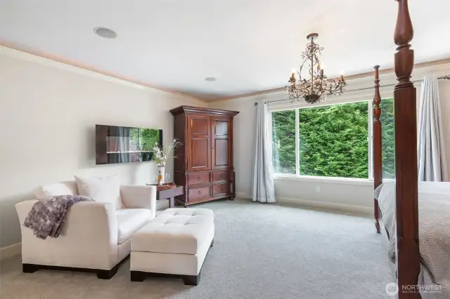 Lavish primary suite overlooking the rear yard.