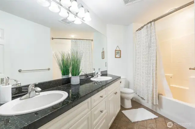 Upper-level hall bath with dual vanity.