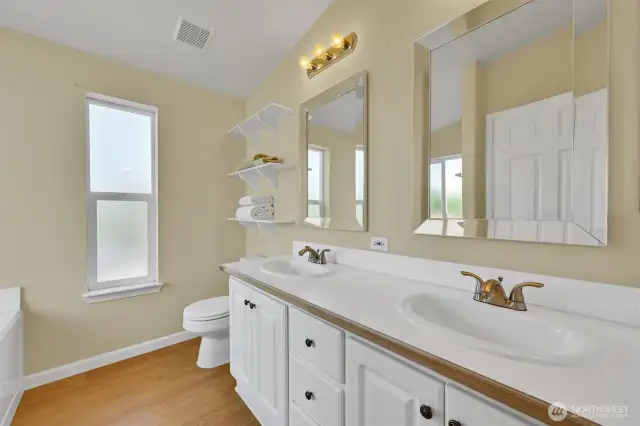 Spacious primary bath with dual sinks and clean finishes.