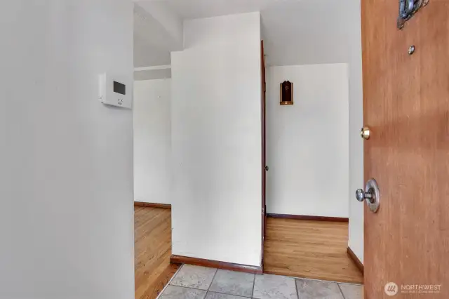 Step into the tile entry, to the left is the large great room circling into the dining and kitchen. To the right you can go down the hallway to the 4 bedrooms, extra living area and garage