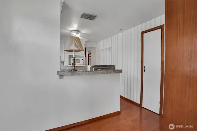 from the kitchen eating area you can see the kitchen and broom closet