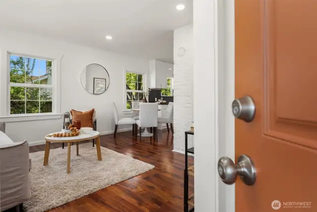 Just inside the covered porch is this formal entry that opens up to the living room with engineered wood floors.