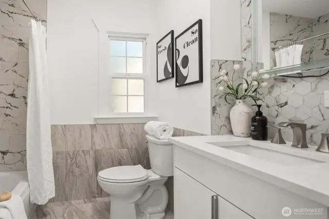 The bathroom features extensive tile work on the floor and surround along with a nice sized vanity with undermount sink.