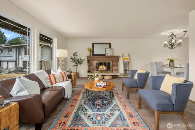To the left of the entrance is a large living room with ample natural light from the 3 picturesque windows.