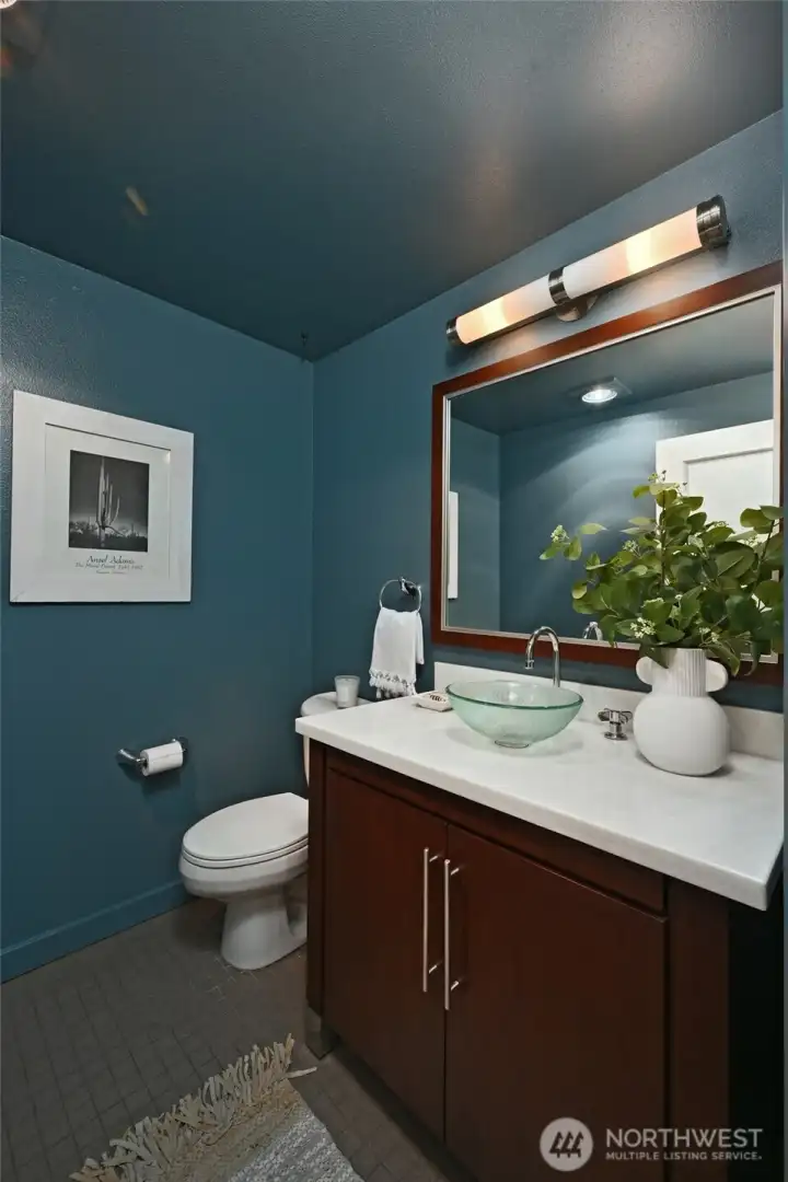 The half bath on the main level has been freshly painted and is ideal while entertaining. It is located just right of the main entry door.