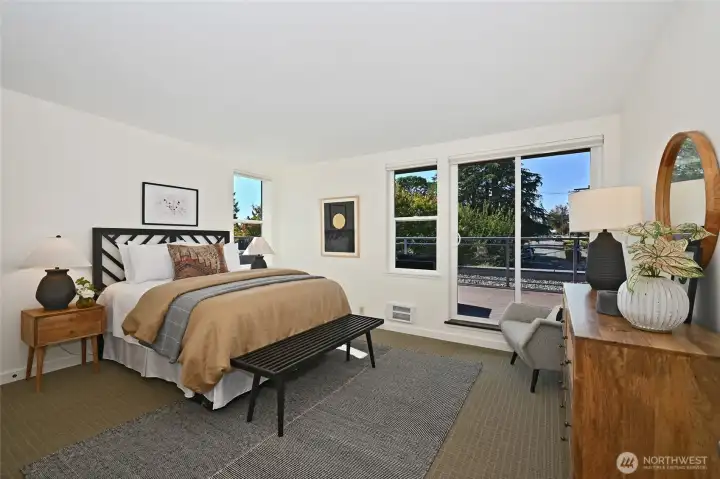 The primary bedroom is large and beautiful and has its own set of sliding doors that lead to the spectacular view deck. Please watch your step as you go in and out!