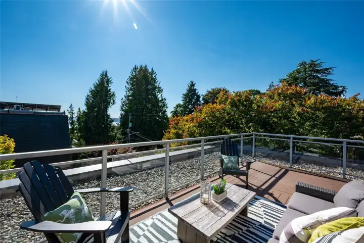 What a stunner! Another characteristic of Mid-Century Modern architecture is the integration with nature which this home does seamlessly through it's expansive 400 sq ft corner deck. It wraps around the home to offer 180 degree views from the east to the west. There is a peek-a-boo view of Elliott Bay and more of the Cascades, the city and territorial views from Queen Anne to Capitol Hill.