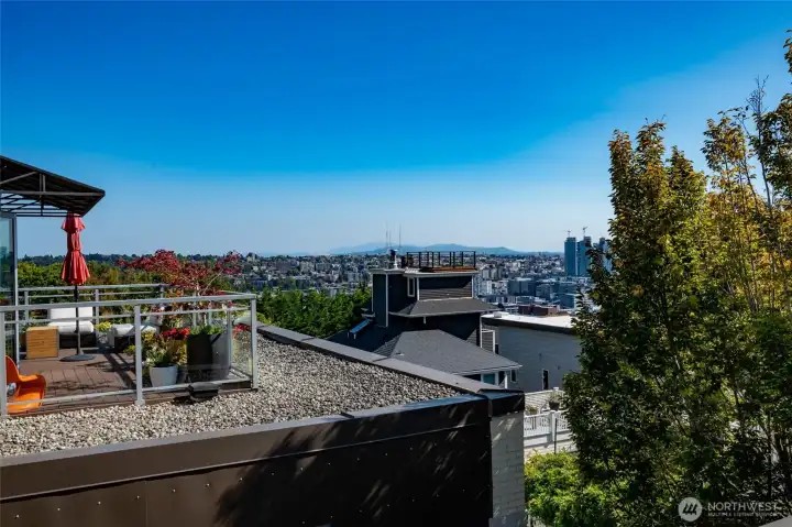 From this home's spectacular 400 sq ft view deck looking southeast to Capitol Hill, the Cascades and the city (the  deck pictured here belongs to the neighbor but is not nearly as close as it appears).