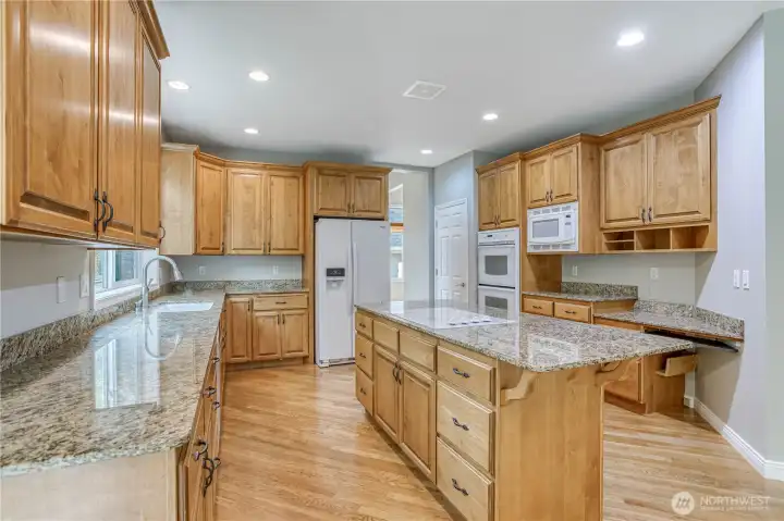 Large kitchen with granite counter tops.