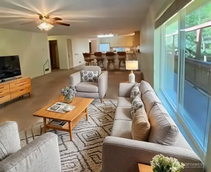 living room virtually staged, shows how it flows into kitchen and dining area