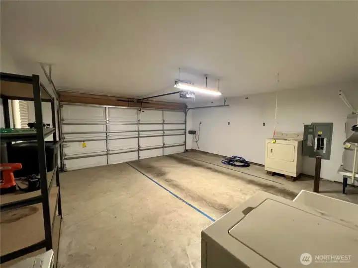 A finished garage, roomy with shelving
