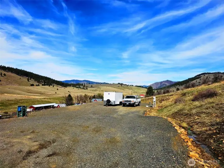 There is plenty of room for extra parking, build a barn, shop or garage on this parking pad. Seller had a nice 12x48 Nobel horse barn on this pad for years. Power/water/RV hookup all ready to go!