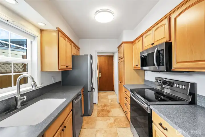 Wonderful butlers kitchen with back storage space with laundry