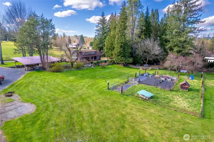 Chicken coop, fenced dog run, fenced garden area.