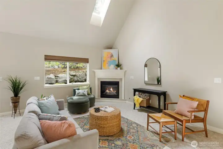 Light filled living room with propane fireplace.