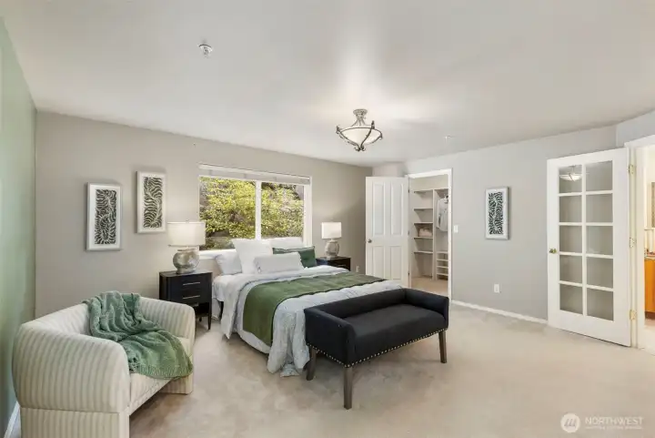 Main floor primary suite with walk-in closet...French doors to the right lead to 5 piece ensuite.