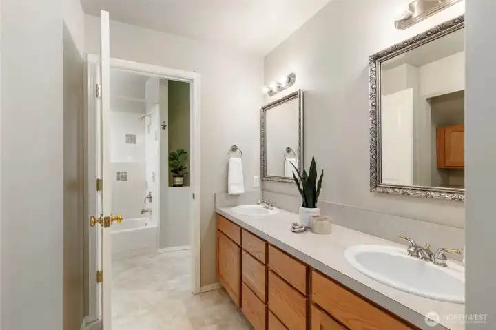 Upstairs shared bath with laundry.