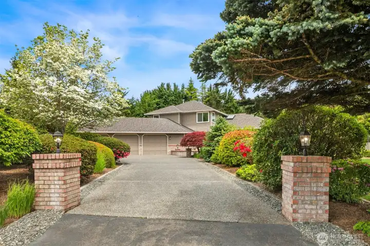 Mature landscaping and circular drive give off airs of grandure