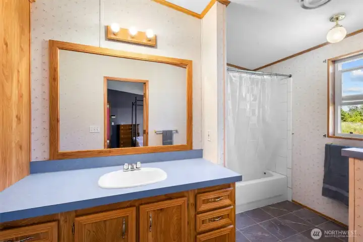 Full bath attached to primary suite has ample storage and counter space. Full bath attached to primary suite has ample storage and counter space.