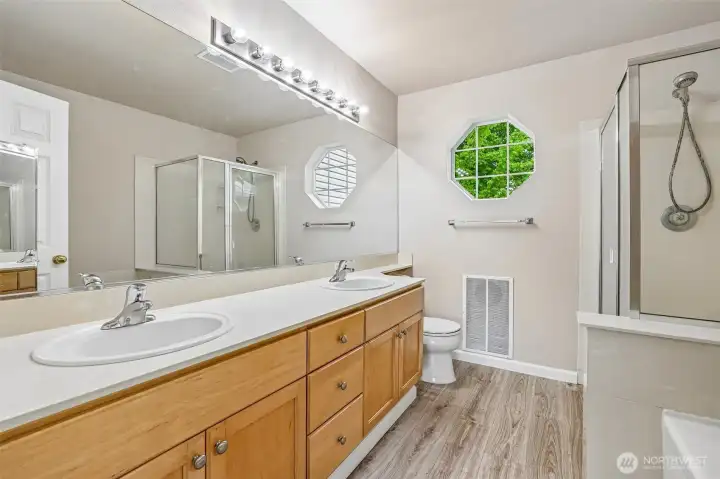 Main bathroom with double sink, shower stall and tub.
