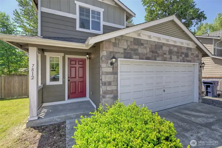 Covered front porch & custom color front door. Covered front porch & custom color front door.