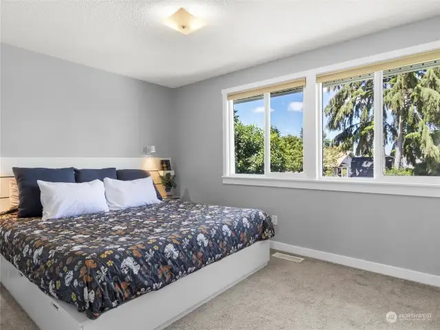Primary bedroom boasts two large windows with lots of natural light and a territorial view of the park like backyard!