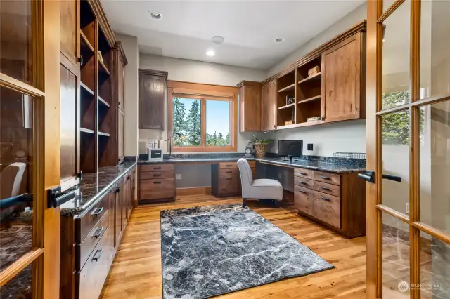 Work in style in one of two elegant home offices on the main floor, this one, complete with built-in desks and glass French doors. This sophisticated space blends productivity and charm.