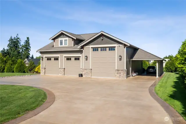 The ultimate dream garage: complete with an RV Bay, carport, a fully-equipped workshop, rod room, laundry, bathroom, and a modern apartment suite above.