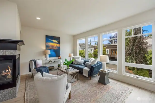 Just upstairs --the main level features open concept living spaces and an easy flowing floorplan with tall ceilings and walls of windows for natural light throughout.