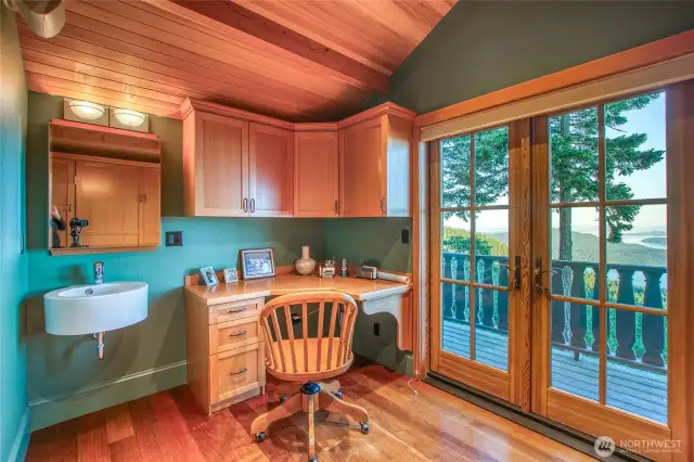Main house second floor has many uses: office/studio/sleeping. The spaces is filled with light. The craftsmanship in the wood wraps you up in nature and then there is the vieiwng deck that just might be where you spend your time day dreaming.