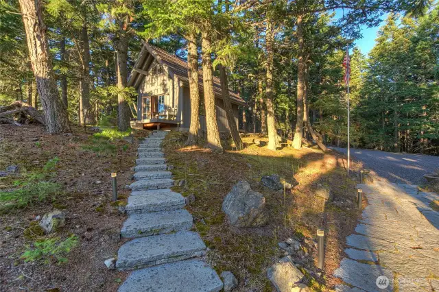 The Sauna Cottage is tucked behind the main house and feels like a hide-away that nobody knows about. Sneak away for a sauna. Be sure to bring a good book. Pathway brings you to the large parking area. I love the native vegetation here, no time-consuming maintenance!