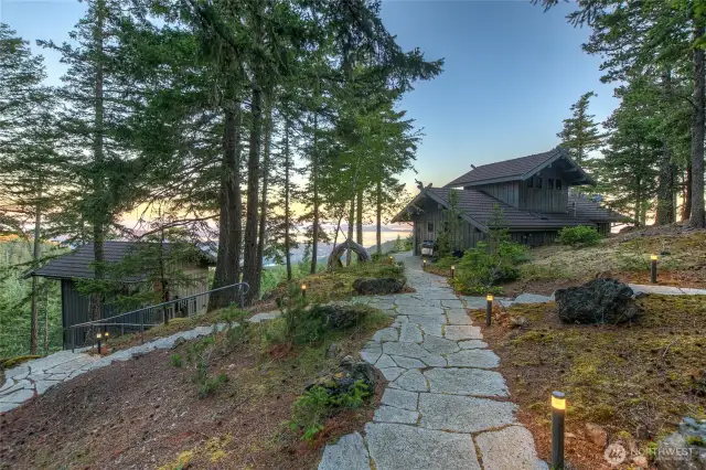 Flagstone pathways and stone staircases with hand railings connect the 4 structures and blends them into the native surrounding vegetation.