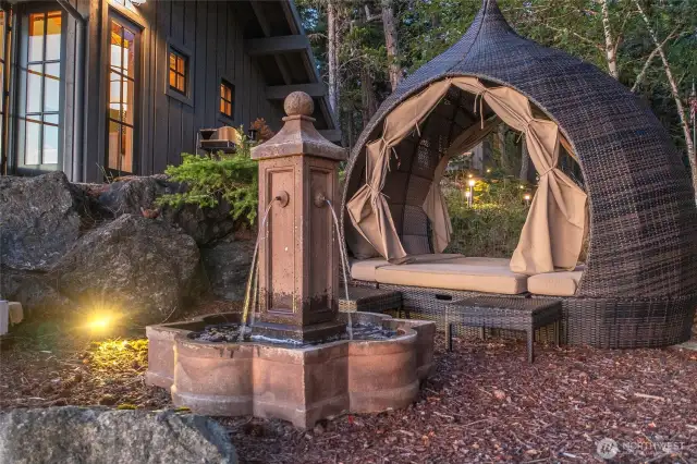 Outdoor lounger with water feature.